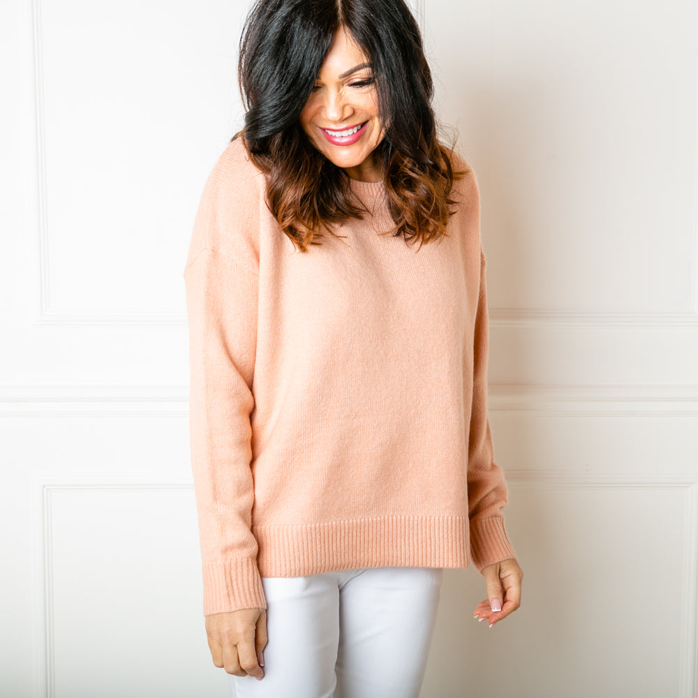 The Essentials Knitted Jumper in peach with ribbing detail around the neckline, cuffs and bottom hemline